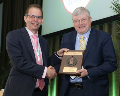 Andrew Lotery, MD, FRCOphth, (00F) presented the Singerman Medal to Stephen Russell, MD