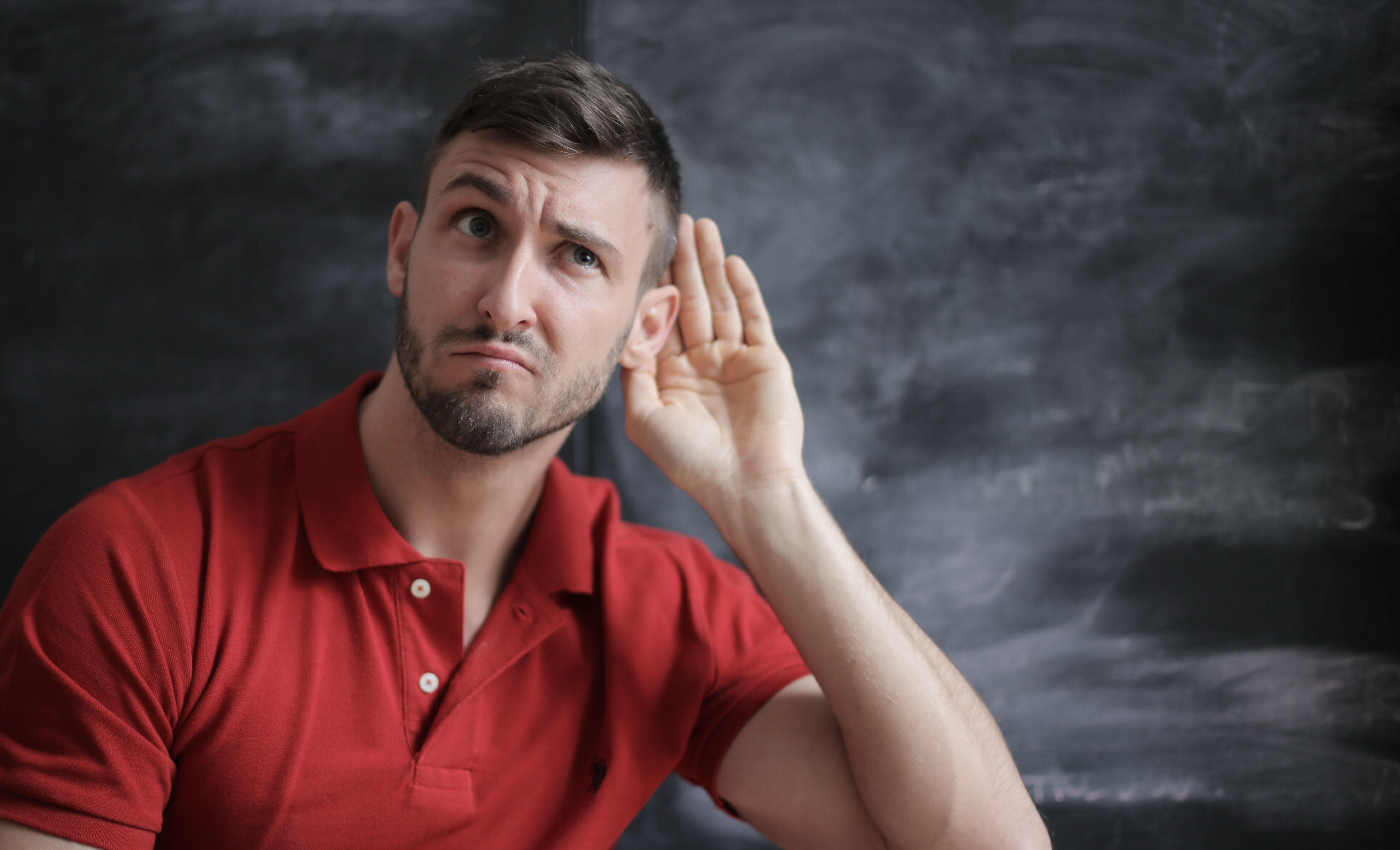 Man cupping ear to listen