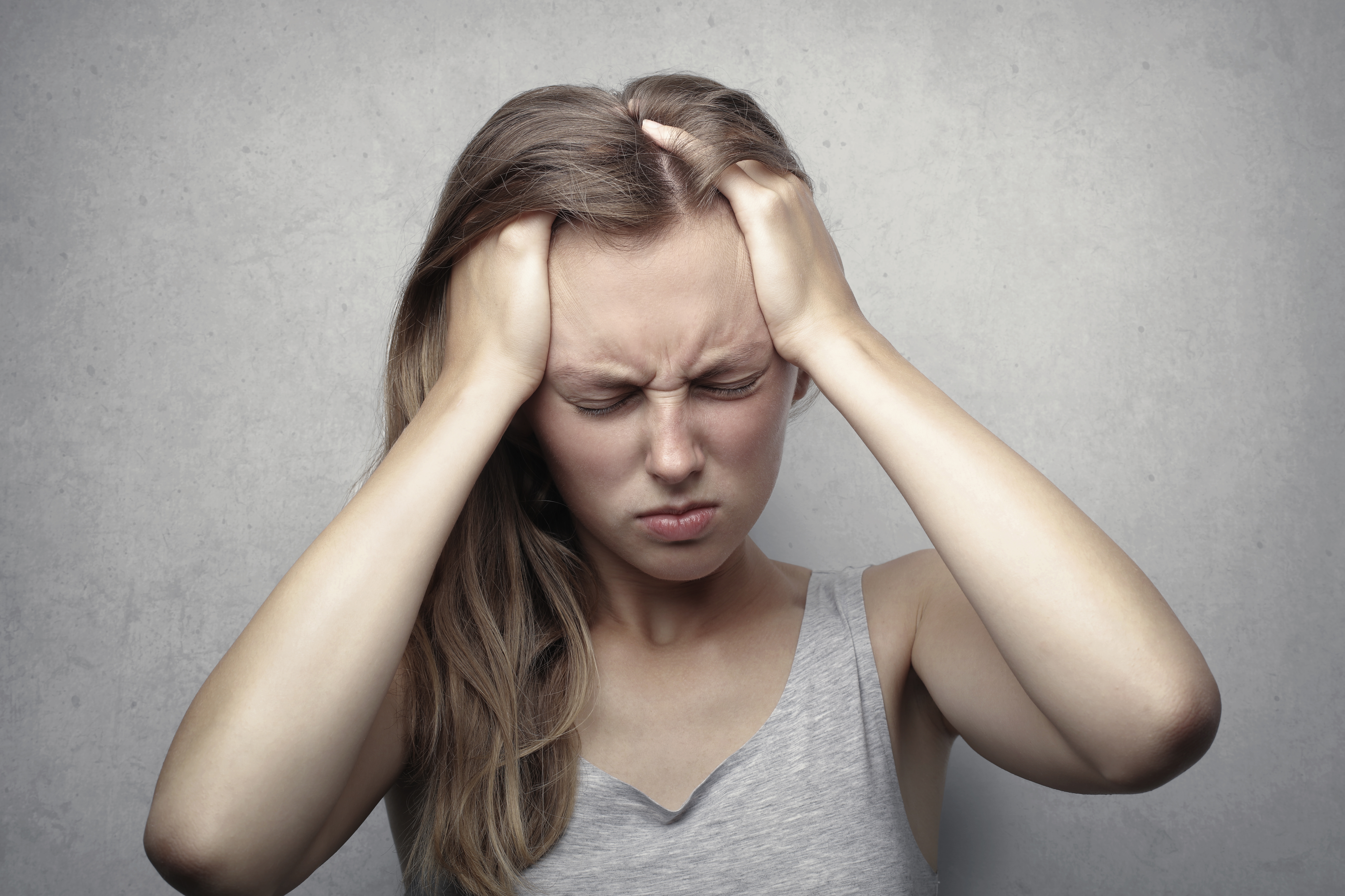 Woman holding ears in pain