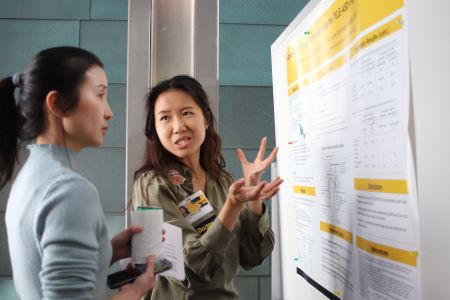 A doctor discusses research with another woman.