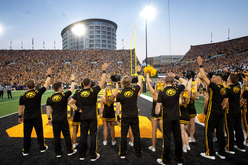 Hawkeye fans and cheerleaders wave to the UI Stead Family Children's Hospital during a football game at Kinnick Stadium.