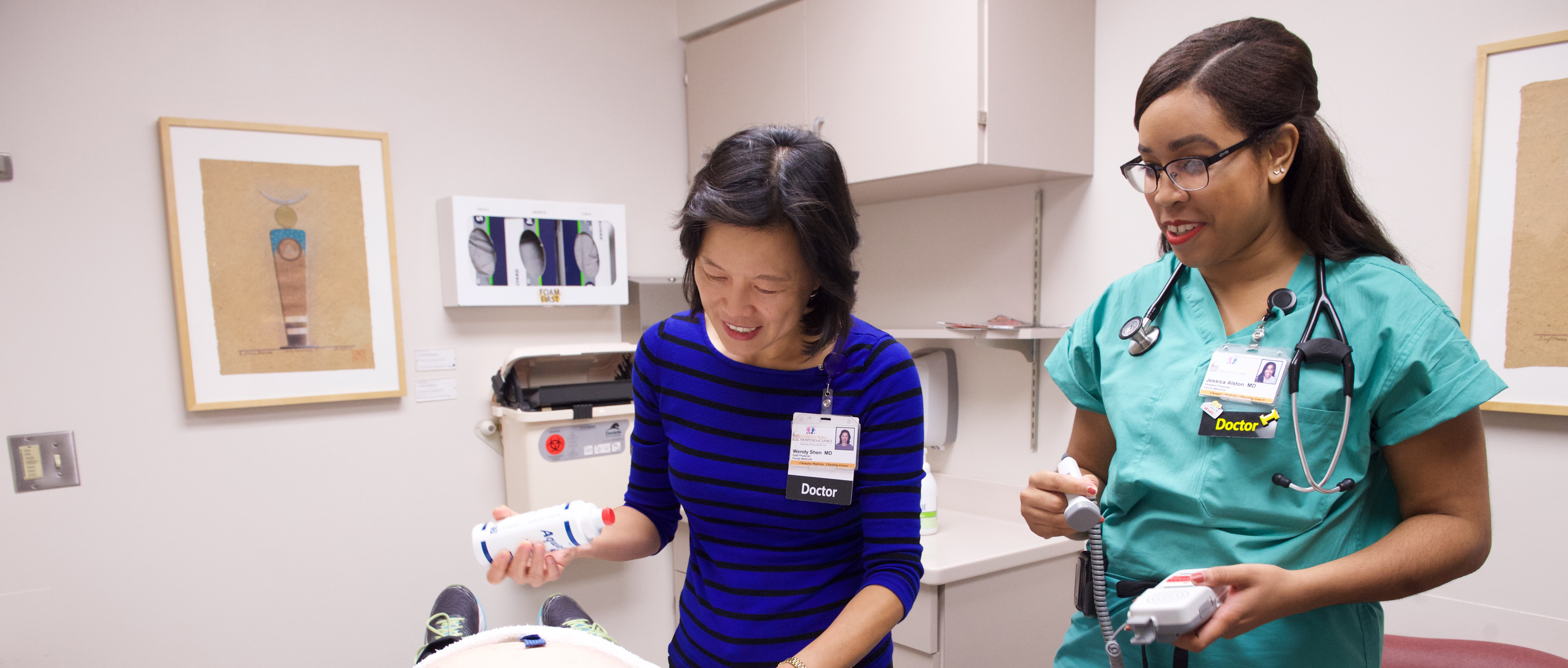 Dr. Shen with resident in the Family Medicine Clinic doing ultra sound on a pregnant patient.