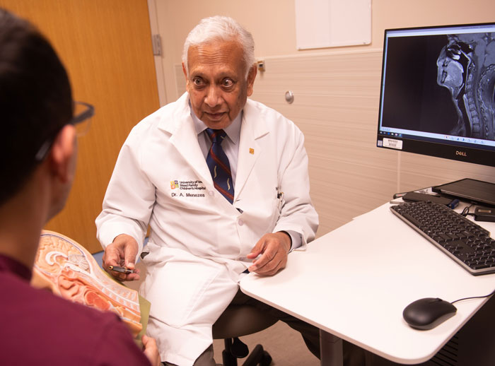 Dr. Menezes teaching resident in clinic