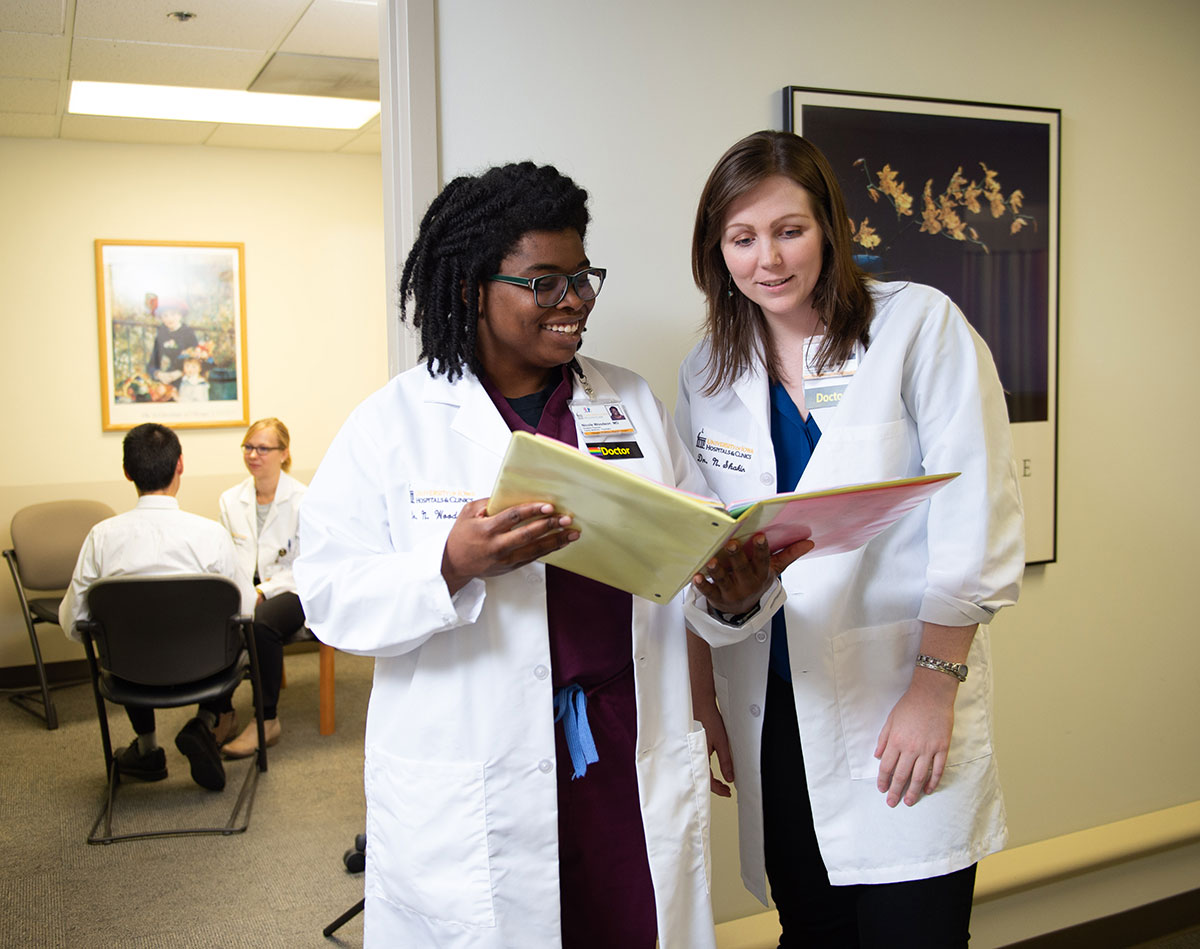 Residents in the hallway looking through files