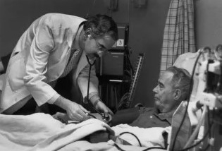 Photo of physician assisting dialysis patient in the dialysis unit