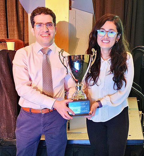 Photo of two GI fellows holding a trophy.