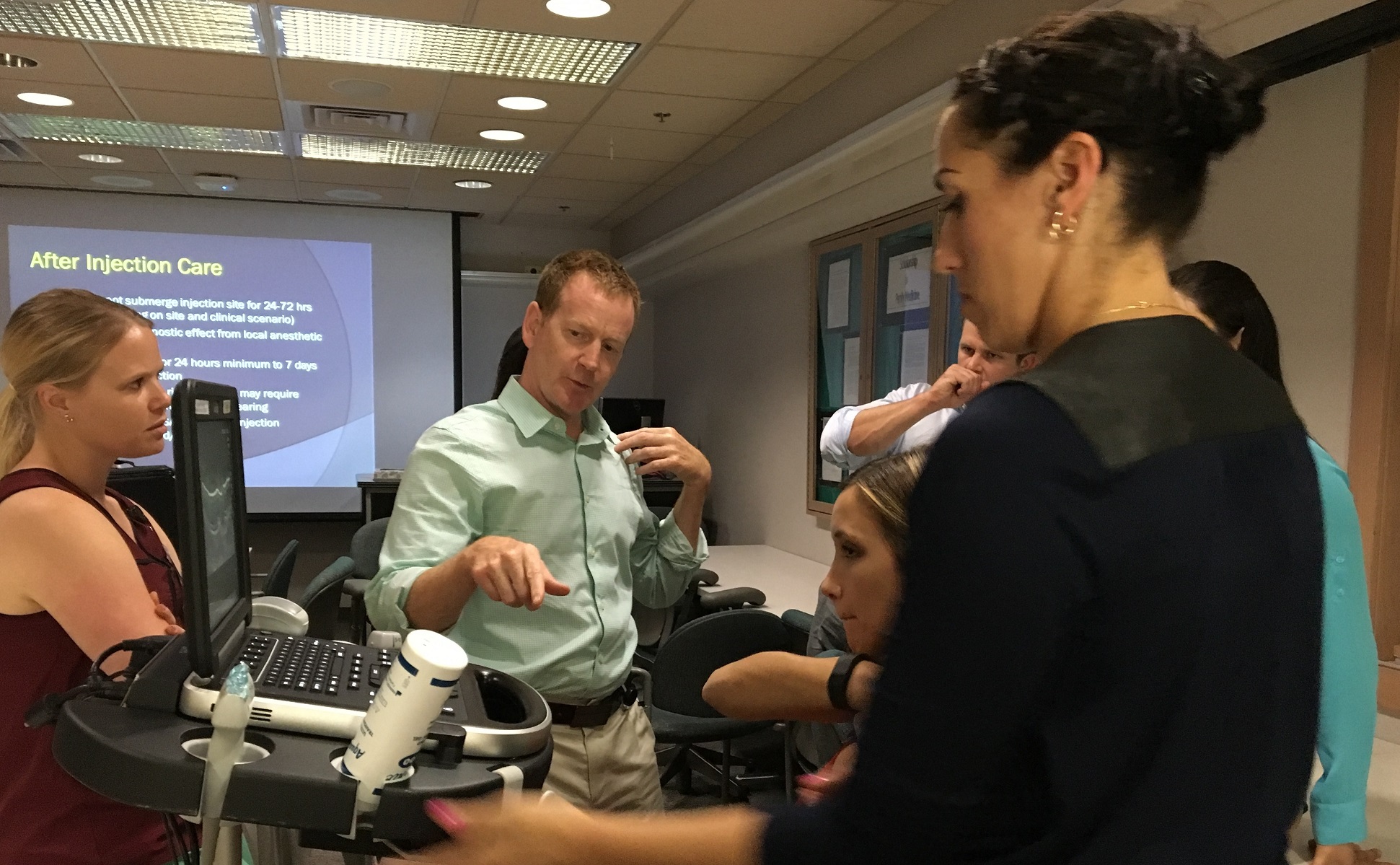 Residents talking together in a lecture setting