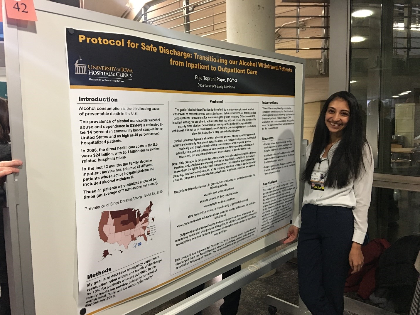 Resident stands at a research board